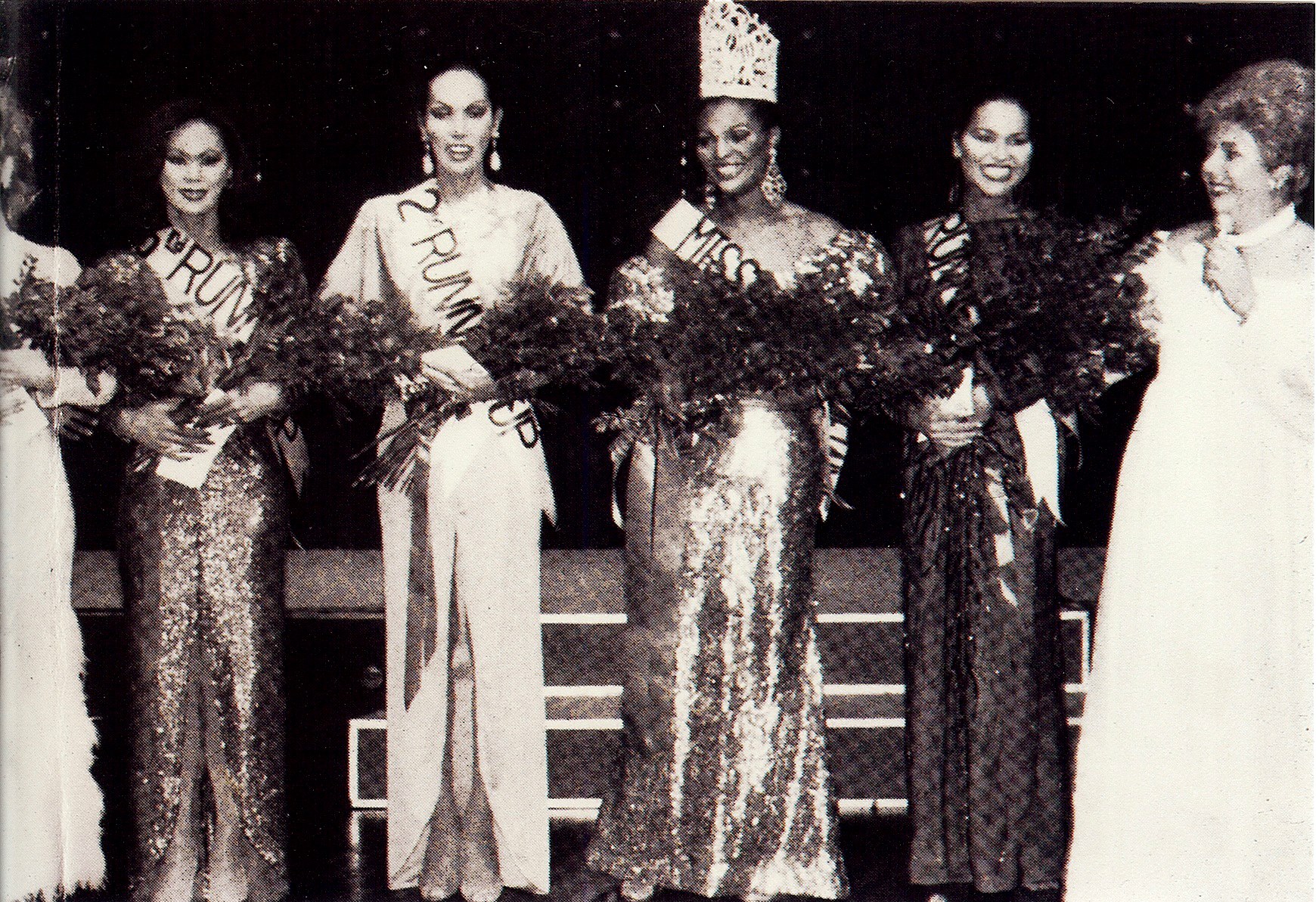 Top Five at Miss Continental 1982 when Tiffany Andretta Arieagus won. Left to Right: Shawna Reese Steel (4th Alternate and barely in photo) , Cherine Alexander (3rd Alternate), Andrea Nicole (2nd Alternate), Tiffany Arieagus (Winner), Dina Jacobs (1st Alternate) and Miss Continental Pageant owner Jim Flint (AKA Felicia).