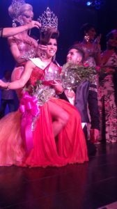 Aurora Sexton, on the knee of Mykul Jay Valentine, being crowned National Entertainer of the Year, F.I. 2011 by the outgoing Vanessa DeMornay.