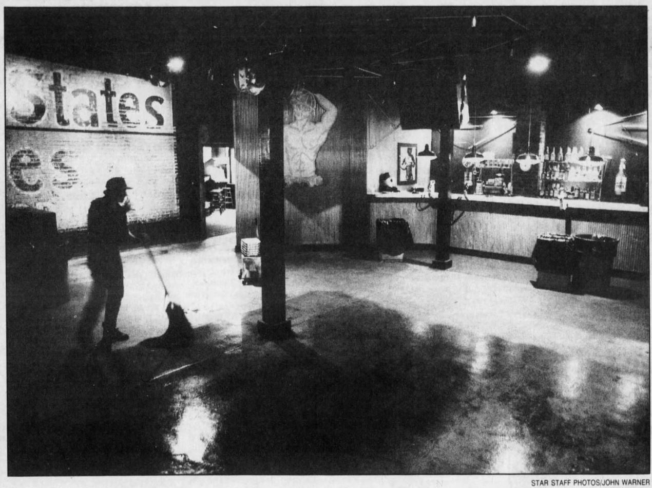 Kerry Earhart mops the dance floor at Our Place to get the bar ready for its 5 p.m. opening. | Our Place (Indianapolis, Indiana) | The Indianapolis Star (Indianapolis, Indiana) | 30 September 1990 | Page 22