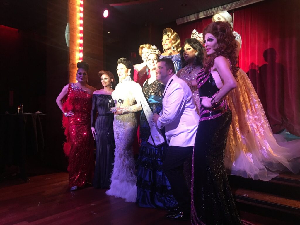 Kelly Ray is front and center after capturing the Miss Gay New America crown.  Identified in this photo are front row: Sabrina White, Aida Stratton, Champagne Bubbles, Kelly Ray, unknown, Andora Te'Tee.  Back Row: unknown, unknown, Suzy Wong and Molly Alice Minx. | Miss Gay New America | Hudson Terrace (New York, New York) | 7/24/2017