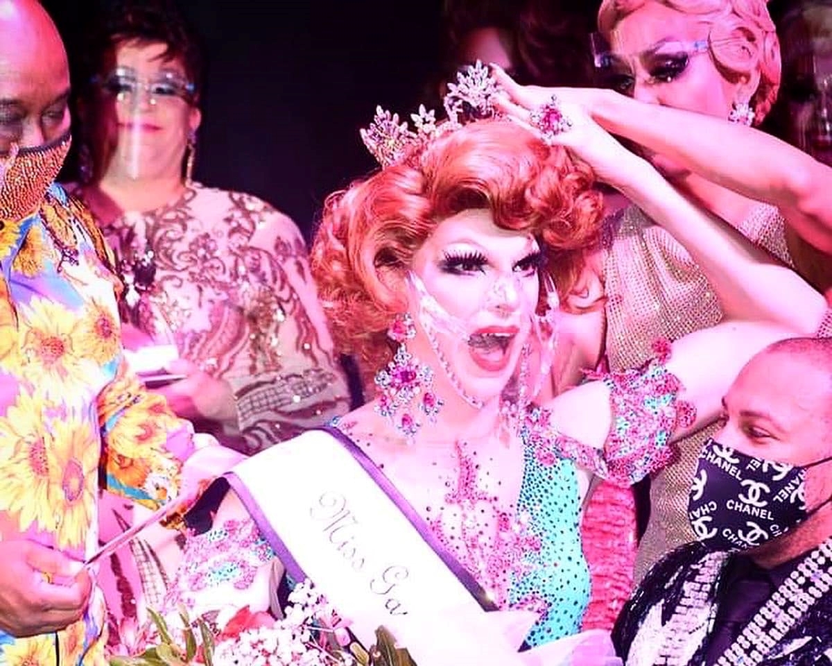 Fifi DuBois seated on the knee of Simba R. Hall is crowned as Miss Gay Sin City America by Pattaya Hart with an assist by Larry Edwards aka Hot Chocolate (far left). | Miss Gay Sin City America | Jimmy's at Madison's (Las Vegas, Nevada) | 4/19/2021 CROPPED