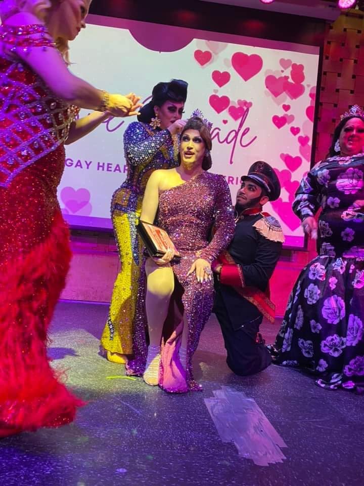 Scarlett Kelly crowns Mimi Sharp the new Miss Gay Heart of Ohio America while she is seated on the knee of Commander Sins. National Holiday can be seen in the right of photo. | Miss Gay Heart of Ohio America | Axis Nightclub (Columbus, Ohio) | 2/5/2022