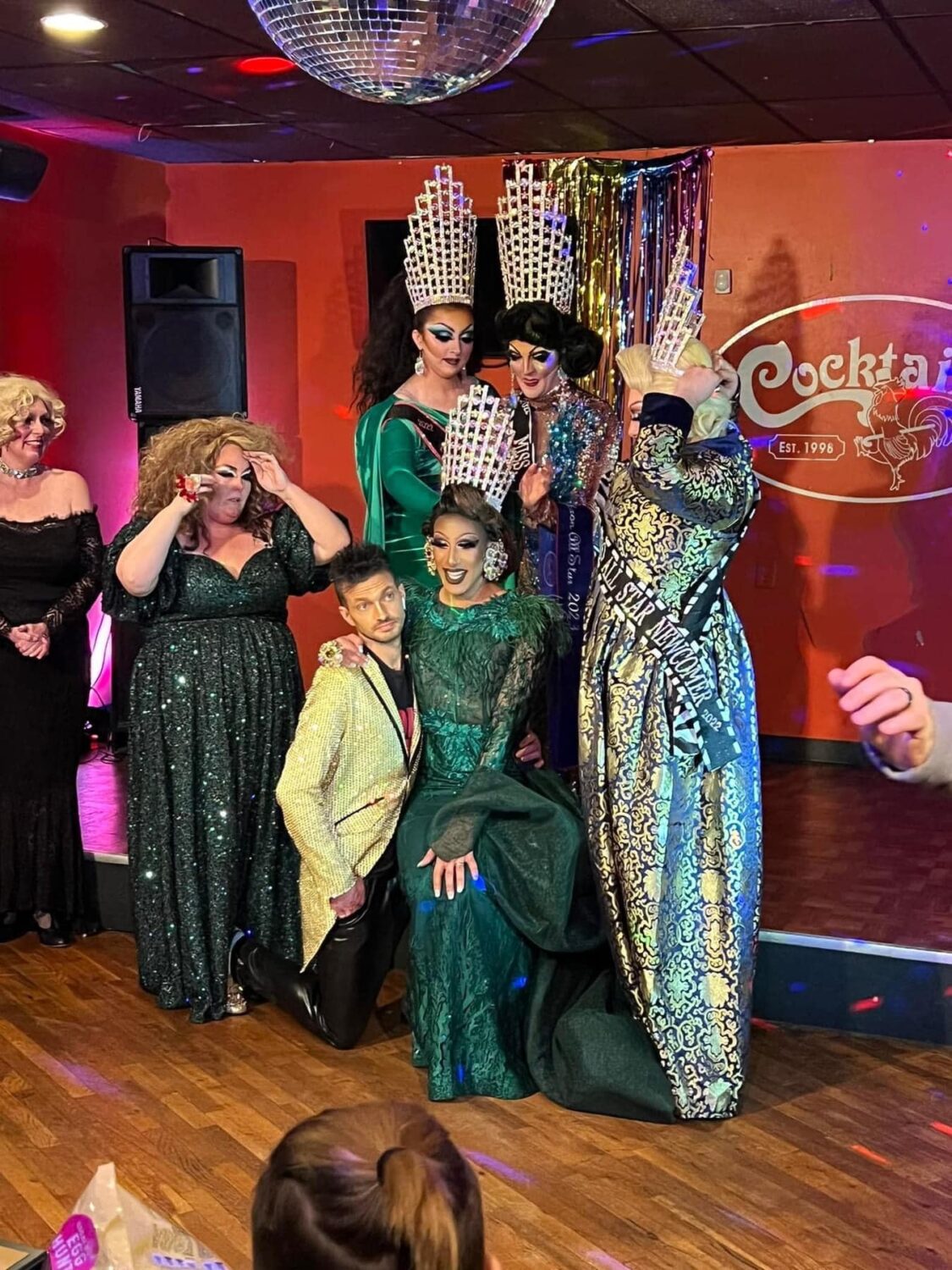 Travis Martinez offers a knee to Pineapple Peruu as she is crowned Miss Akron All-Star 2023 by Lady B Aura, Malibu Peruu and Zoey Zegai. | Akron All-Star Pageant | Cocktails (Akron, Ohio) | 2/18/2023